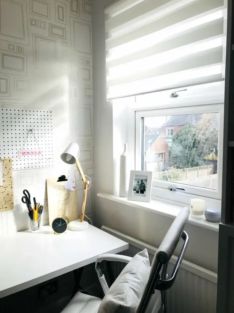 Home office with glare on the screen from a nearby window