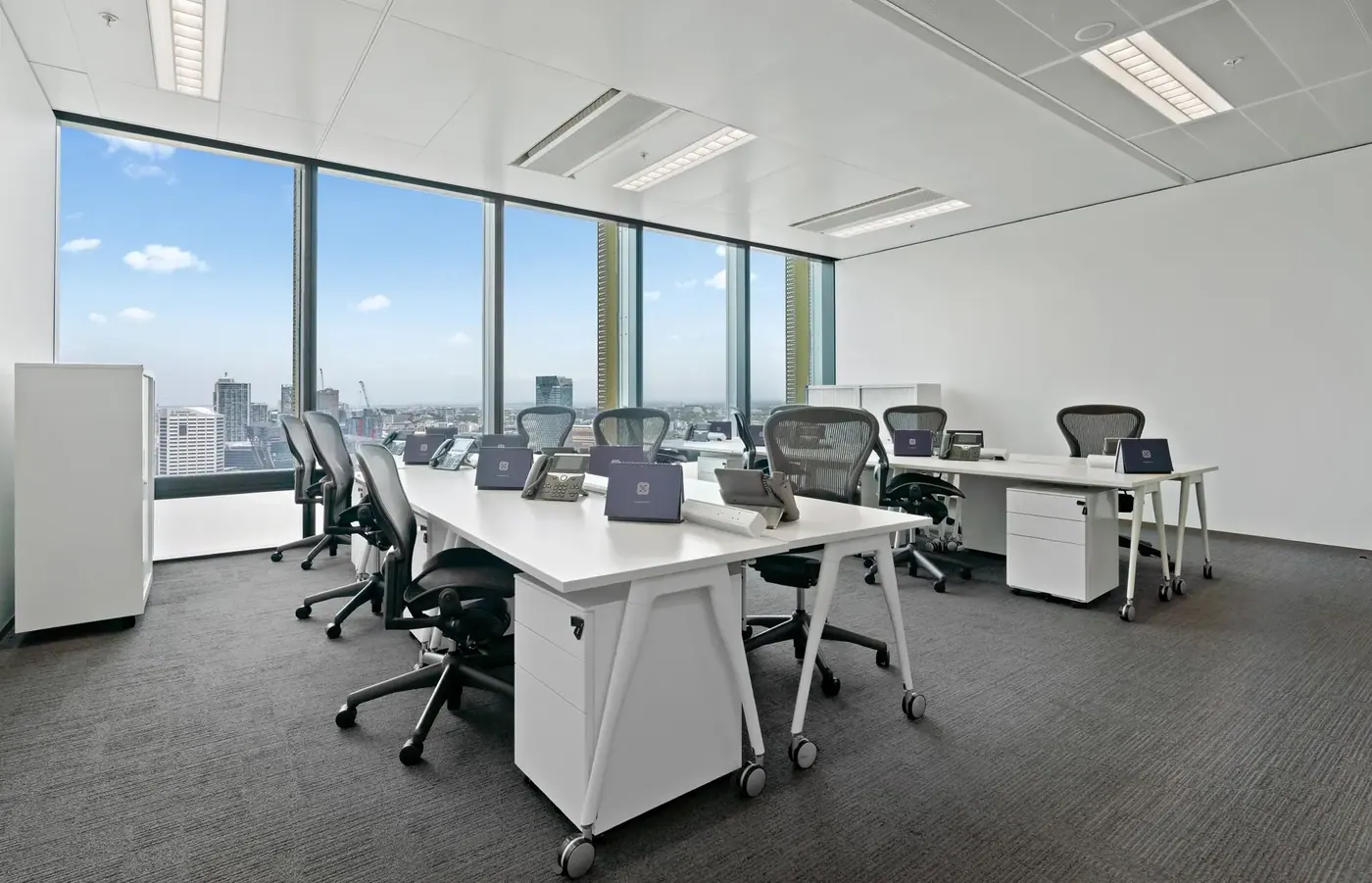 Open plan office with large windows fitted with window film